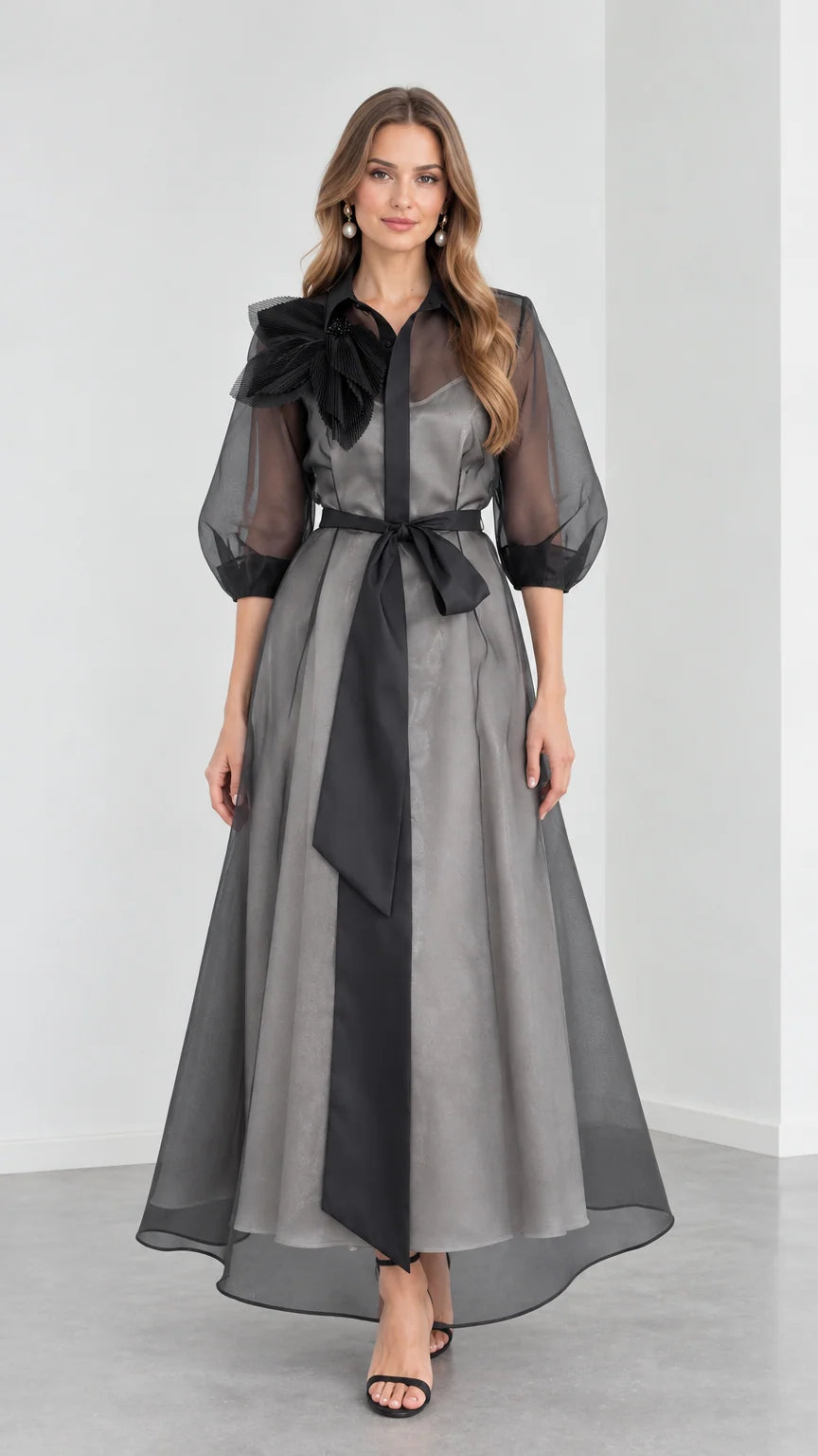Full front view of model wearing Charcoal Grey organza collared maxi shirt dress with black sash and 3D floral shoulder detail