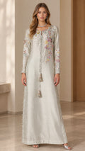 Front view of model wearing silver embroidered maxi kaftan dress with tassel ties