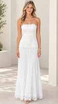 Front view of woman wearing white strapless floral lace maxi dress with scalloped neckline