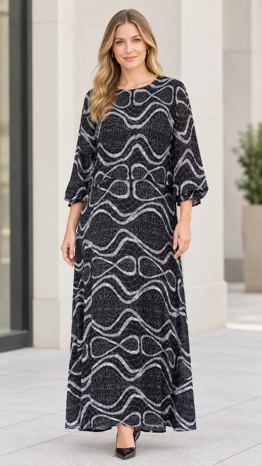 Front view of model wearing black abstract wave print maxi dress with long sleeves