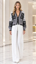 Model wearing heather gray sequin embellished knit cardigan front view with wide-leg pants
