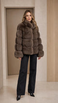 Front view of model wearing taupe paneled faux fur jacket with wide-leg jeans