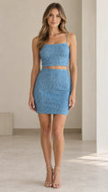 Front view of model wearing light blue sequin two-piece crop top and mini skirt set