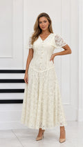Full-length front view of cream floral lace maxi dress with capelet sleeves and button front