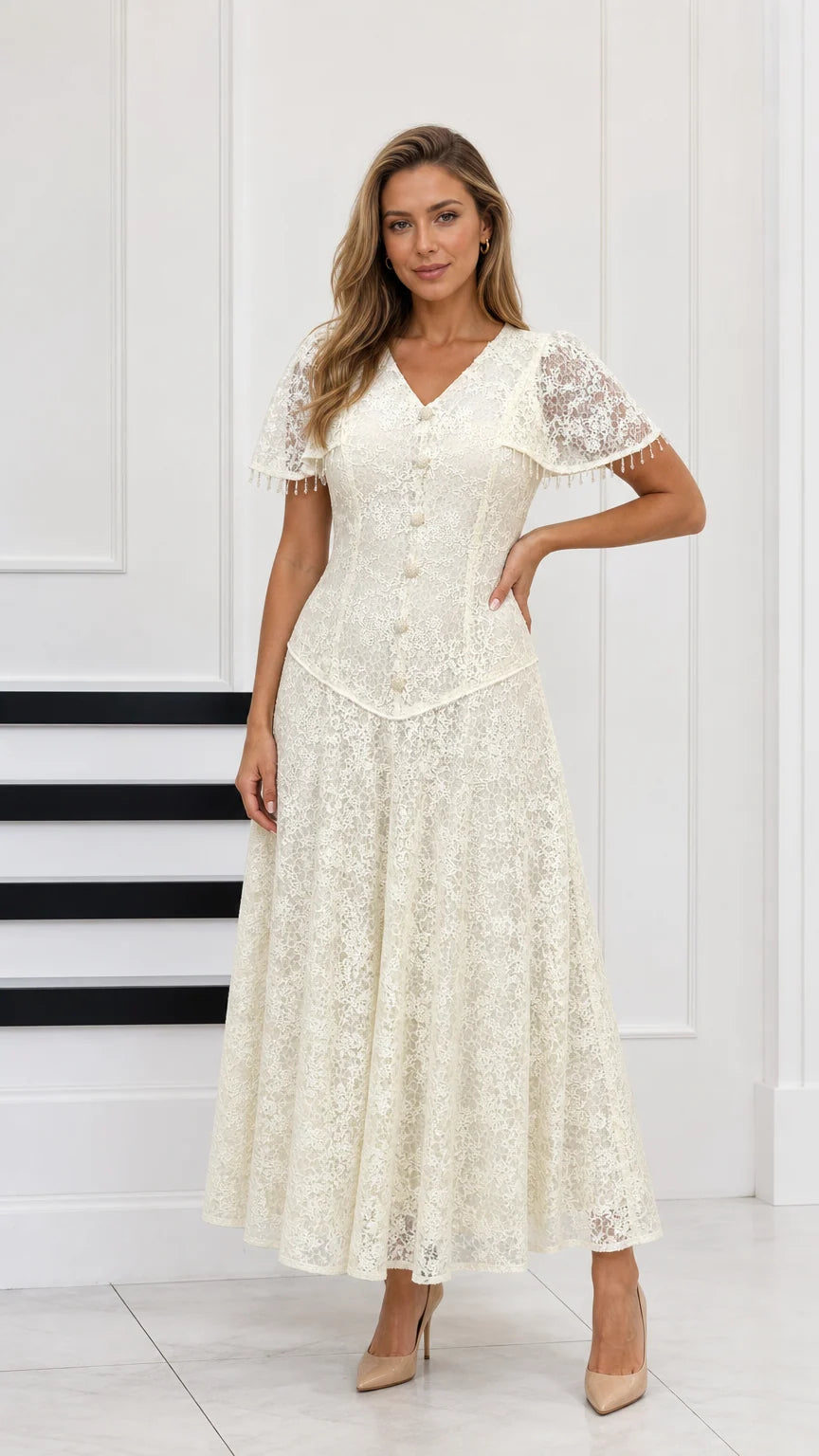 Full-length front view of cream floral lace maxi dress with capelet sleeves and button front