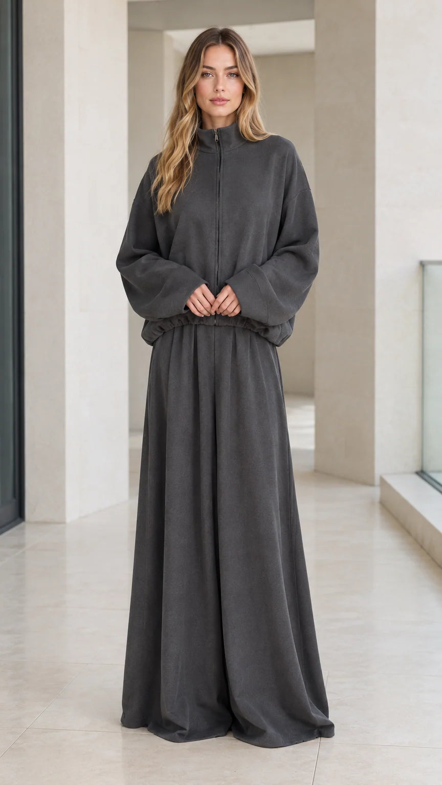Front full view of woman wearing charcoal grey zip-up mock neck jacket and wide-leg lounge pants set