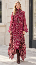 Model wearing Burgundy printed long sleeve maxi dress with tie neck and handkerchief hem
