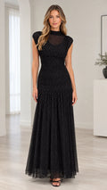 Front full-length view of model wearing black sparkle mesh mock neck ruched maxi dress