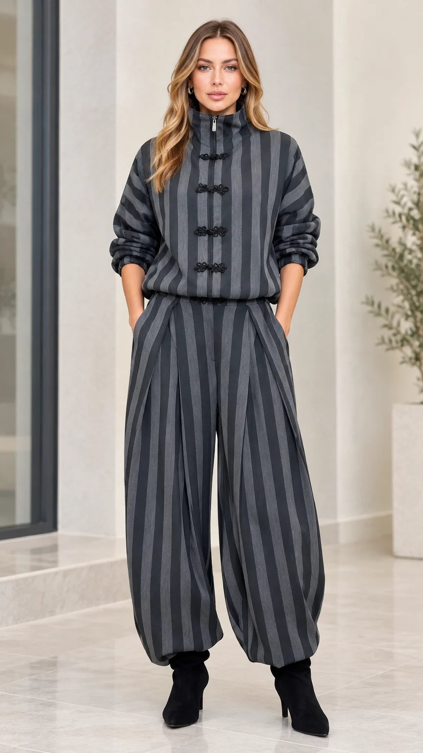 Front full-length view of model wearing charcoal grey striped funnel neck top and lantern pants set