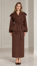 Front view of model wearing chocolate brown belted peplum jacket and maxi skirt set