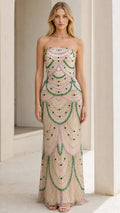 Front view of model wearing the champagne beaded strapless evening gown