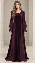 Front view of woman wearing burgundy velvet maxi evening gown with sheer bishop sleeves