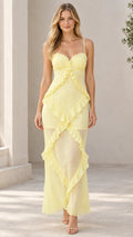 Front view of model wearing pastel yellow sweetheart cascading ruffle cami maxi dress