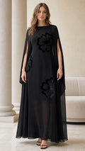 Full front view of black floral flocked chiffon cape sleeve maxi dress