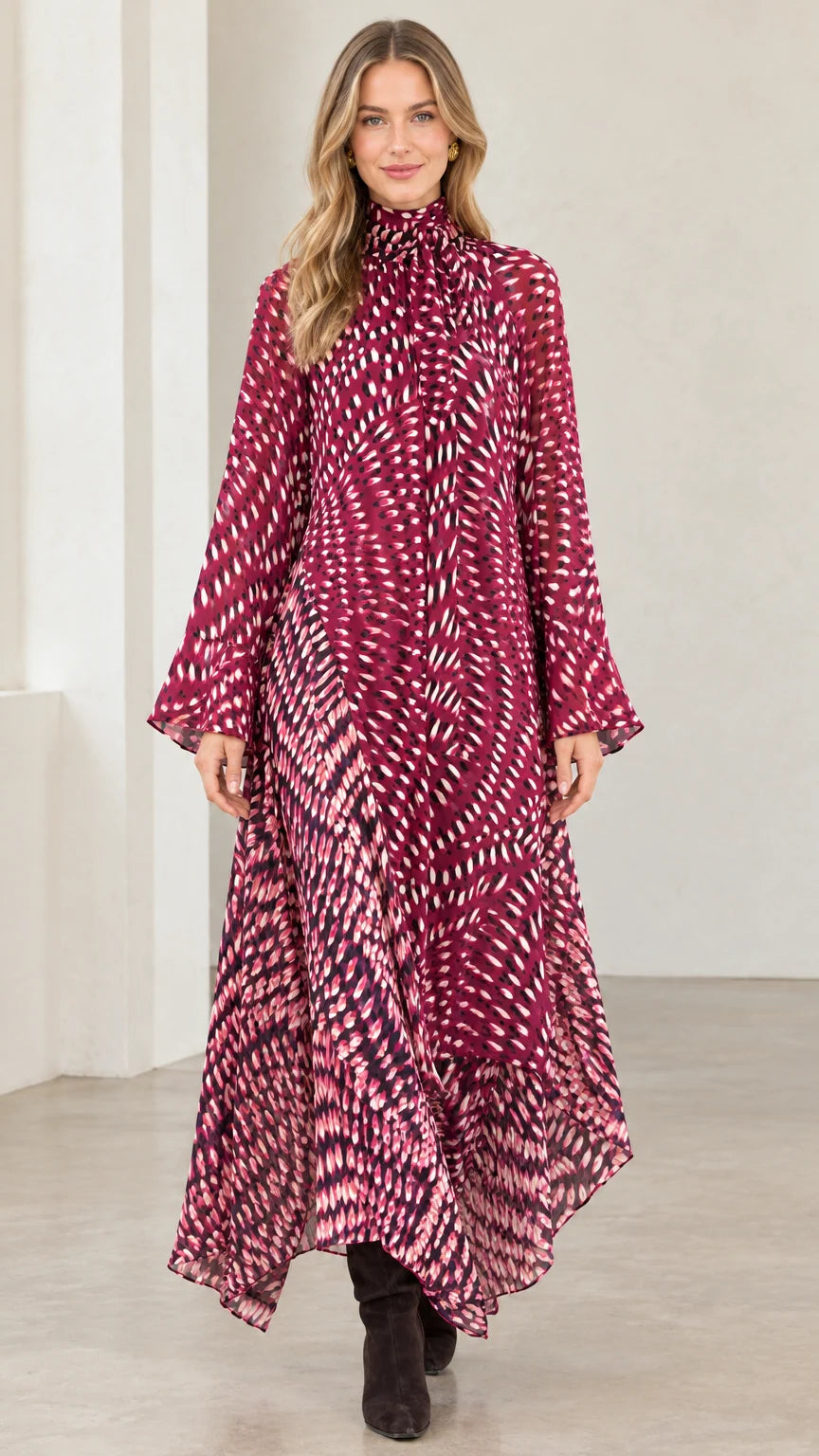 Front view of model wearing magenta abstract print high neck asymmetrical maxi dress