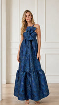 Front view of blue sleeveless brocade maxi dress with front bow