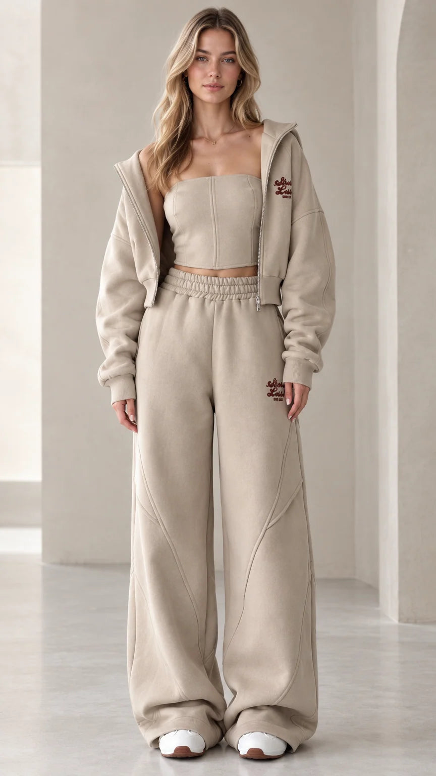 Front view of model wearing the oatmeal 3-piece cropped hoodie and wide-leg sweatpants set