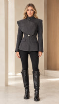 Full front view of model wearing the Charcoal asymmetric tailored jacket with black leggings and knee-high boots