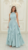 Front view of light blue halter neck pleated maxi dress with cascading ruffles