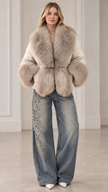 Front view of woman wearing cream faux fur trim puffer jacket with wide leg jeans