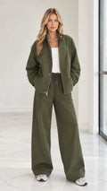 Front full view of woman wearing olive green 2-piece zip jacket and wide leg pants set