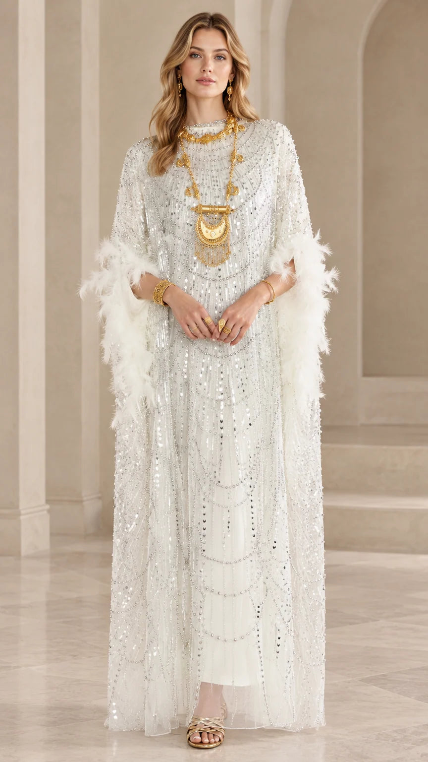 Front view of model wearing white sequin kaftan maxi dress with feather trim sleeves