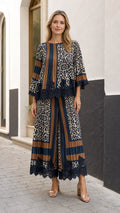 Full front view of model wearing the navy blue and caramel pleated leopard print two-piece set with lace trim