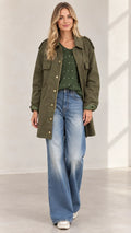 Front full view of women's army green utility jacket paired with wide-leg jeans