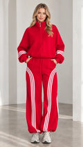 Front view of woman wearing red zip-up jacket and wide-leg striped track pants set