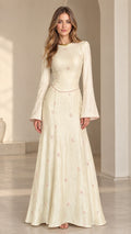 Front view of model wearing cream floral jacquard bell sleeve maxi dress