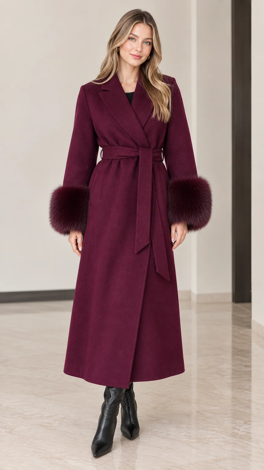 Full front view of model wearing burgundy maxi wrap coat with faux fur cuffs and tie belt