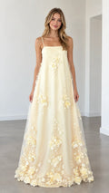 Model wearing butter yellow 3D floral applique spaghetti strap maxi dress front view