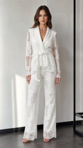 Front view of woman wearing white lace blazer and wide-leg pants set