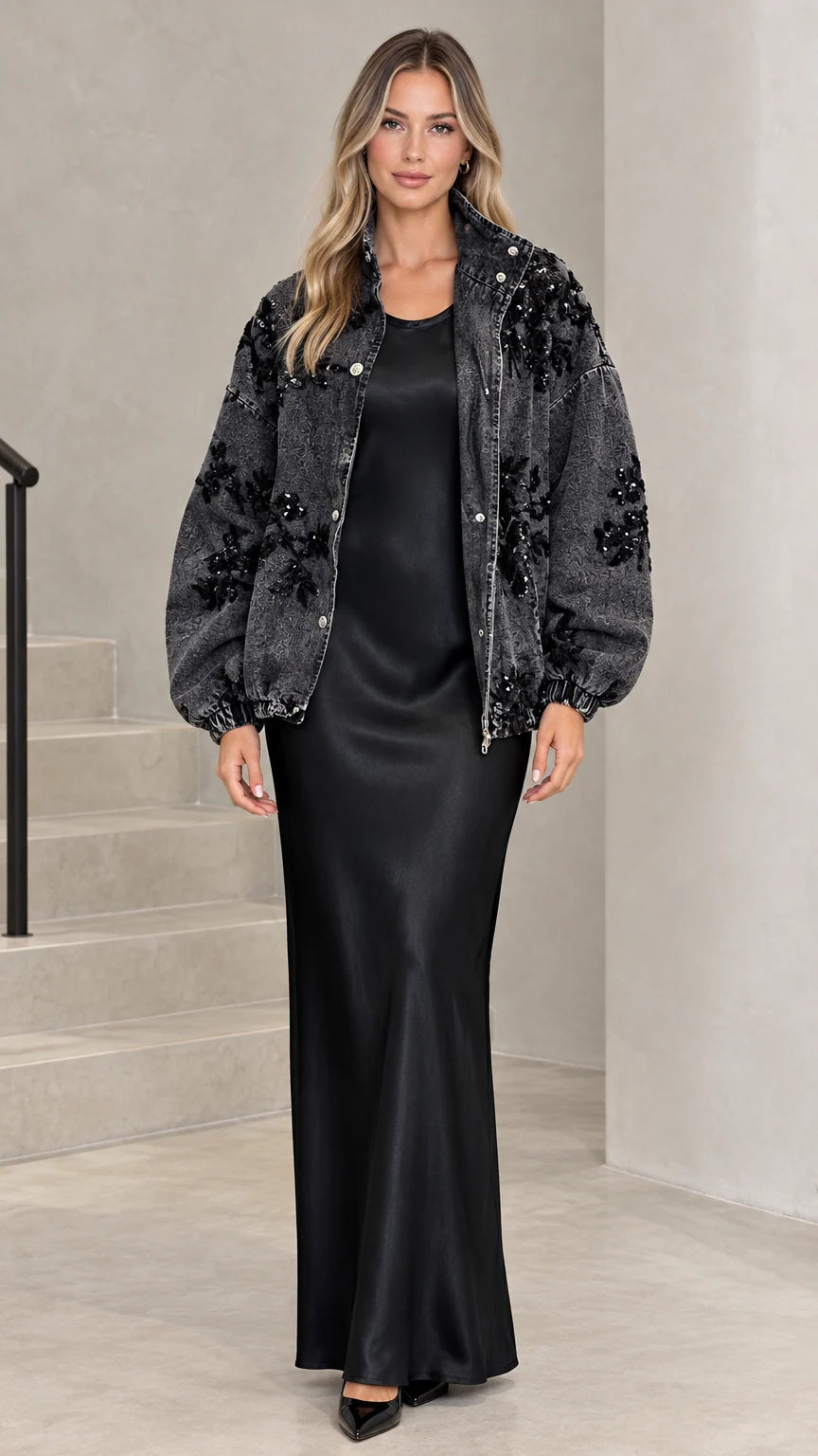 Washed black floral sequin embellished denim jacket styled over a black satin slip dress