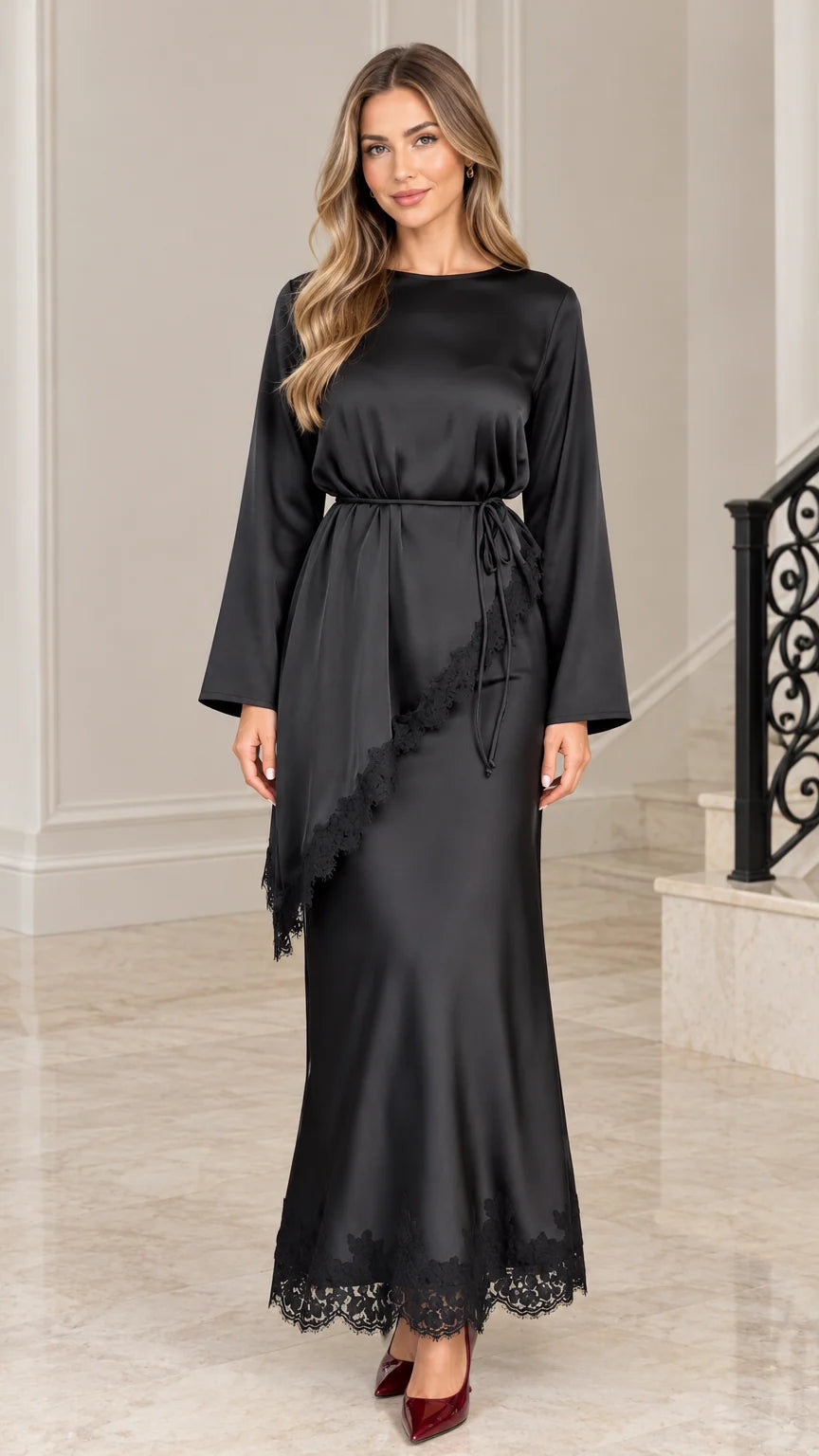 Front full-length view of woman wearing black satin maxi dress with lace trim and tie waist