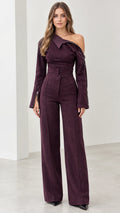 Front view of model wearing plum asymmetric off-the-shoulder wide-leg jumpsuit