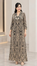 Women's long sleeve sequin-accented printed maxi dress in champagne gold front view