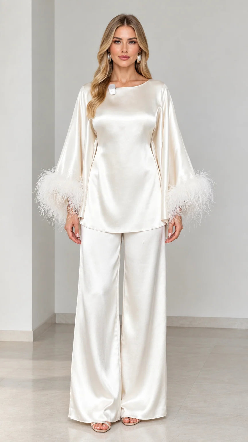 Model wearing ivory satin two-piece set with feather trim cuffs front view