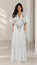 Front view of woman wearing elegant ice blue embroidered flutter sleeve maxi dress