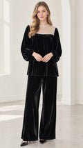 Front full-length view of model wearing black velvet lace yoke top and wide-leg pant set