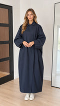 Front full-length view of woman wearing navy blue oversized maxi trench coat