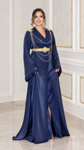 Full front view of navy blue satin kaftan maxi dress with gold shoulder chains and belt