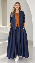 Front view of model wearing Navy Blue pleated maxi duster coat