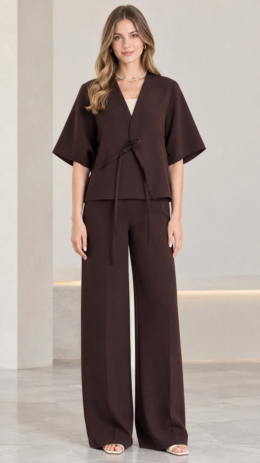 Front view of woman wearing chocolate brown tie-front short sleeve top and wide-leg pants set
