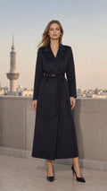 Front view of woman wearing navy blue maxi wrap overcoat with belt