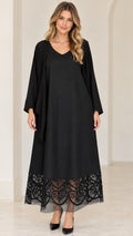 Front view of black V-neck maxi dress with sheer lace hem and draped cardigan overlay