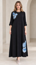 Full front view of black floral appliqué A-line maxi dress on model