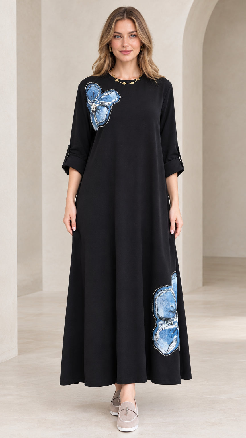 Full front view of black floral appliqué A-line maxi dress on model