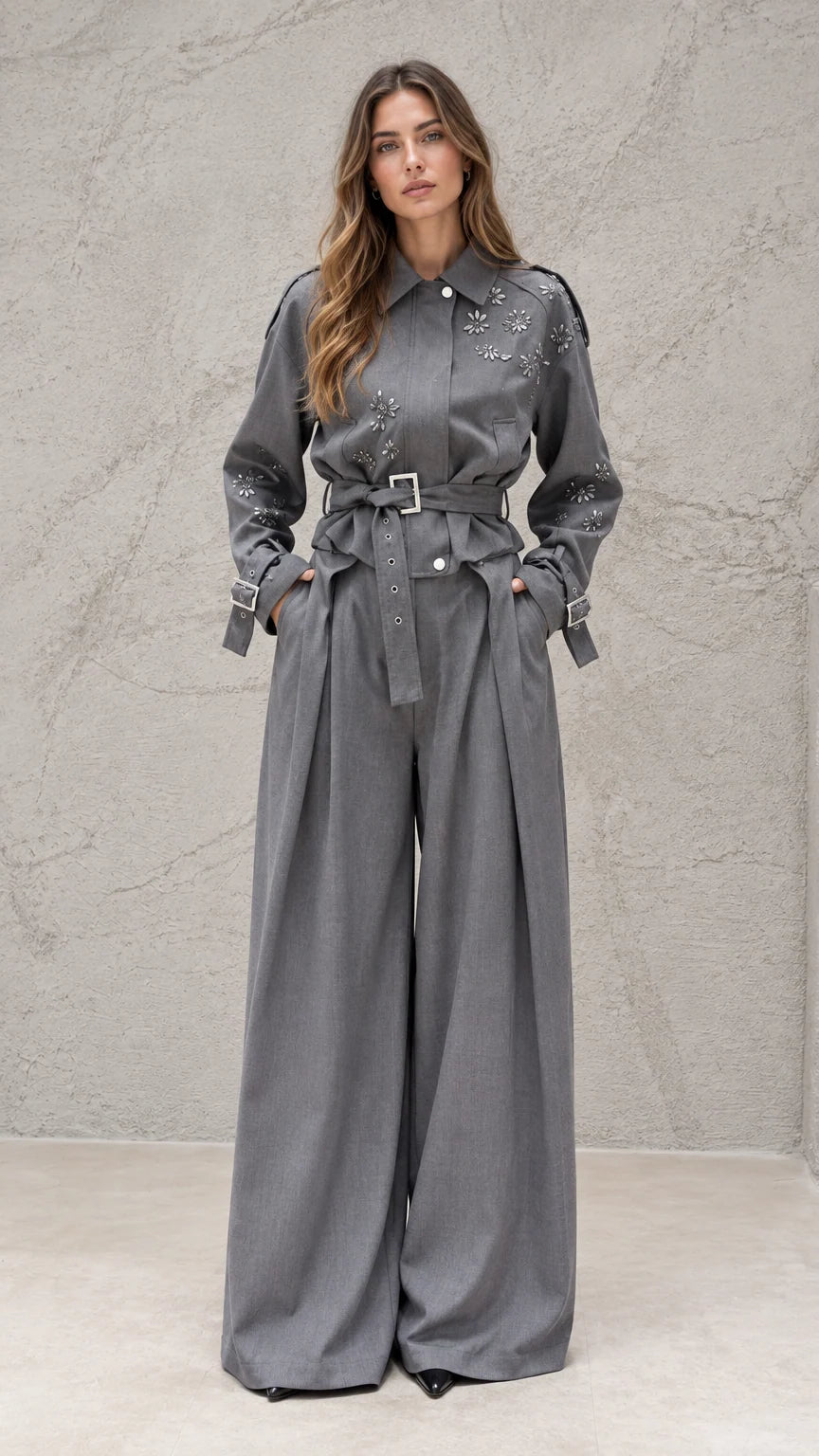 Full front view of model wearing grey embellished belted wide-leg jumpsuit