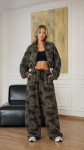 Front view of model wearing army green camouflage cropped zip jacket and wide-leg pants set